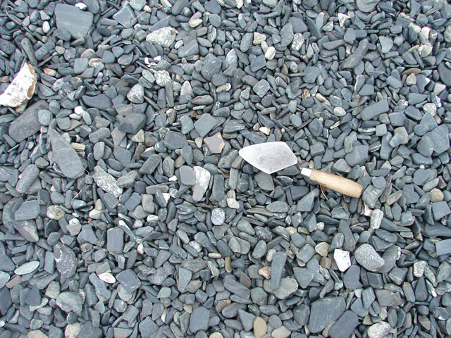 A sherd of a Normandy coarse stoneware jar, practically invisible on the stony beach.